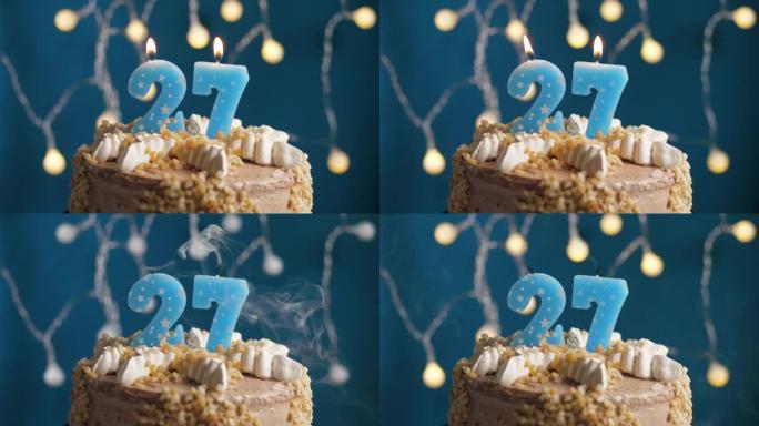 蓝色背景上有27个数字蜡烛的生日蛋糕。蜡烛吹灭了。慢动作和特写视图