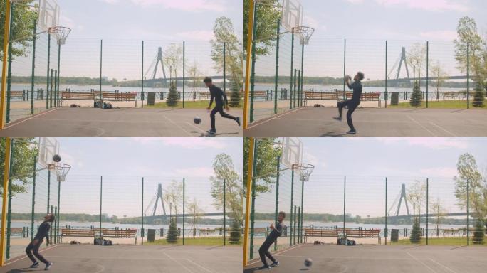 运动型迷人的非洲裔美国男子篮球运动员的肖像把球扔进篮筐，在城市户外的球场上庆祝，背景是桥