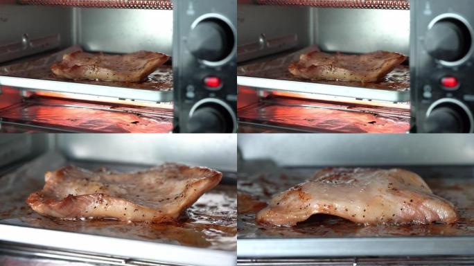 用铝箔放在托盘上的电烤箱烤猪肉。