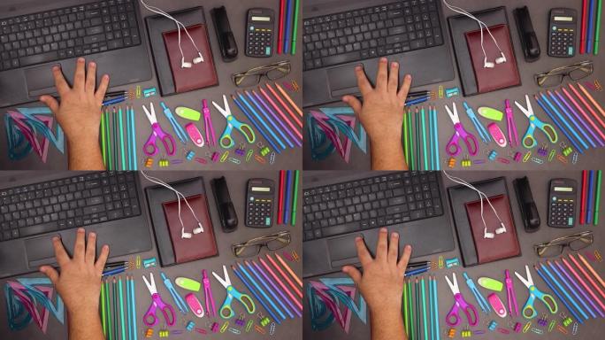男子用手指在带商务用品的桌子上的现代笔记本电脑上的触摸板上滚动 -- 停止运动