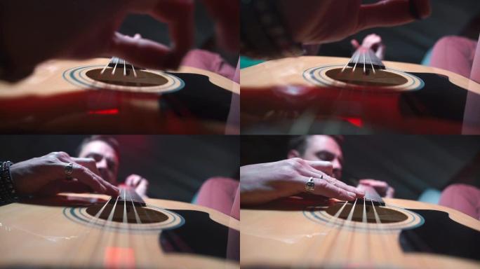 声学吉他手的手的特写镜头。