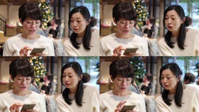 日本女子在咖啡馆的智能手机上打字信息