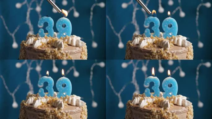 蓝色背景上有39号蜡烛的生日蛋糕。蜡烛着火了。慢动作和特写视图