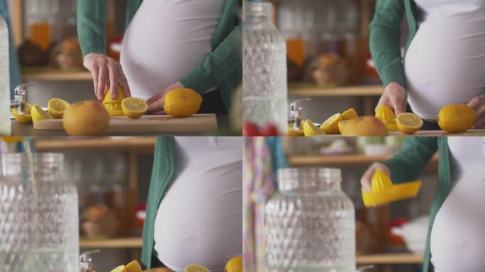 孕妇的中段挤压并将新鲜的柠檬汁倒入玻璃水罐中