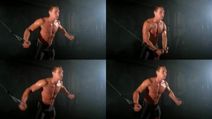 运动员在健身房训练胸部肌肉时使用绳索交叉机锻炼。