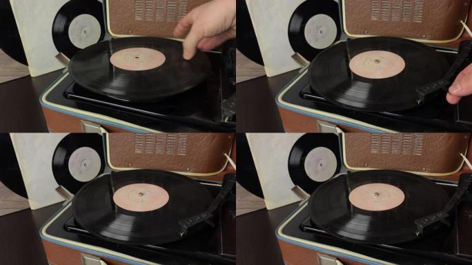 一名男子将黑胶唱片放在电唱机的光盘上。将拾取针设置到光盘轨道并开始播放。