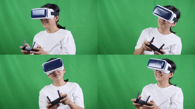 亚洲女性在绿屏上使用VR眼镜和控制无人机