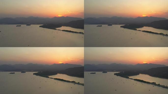 杭州市日落灯光飞行在著名的湖泊旅游水上交通空中全景4k中国