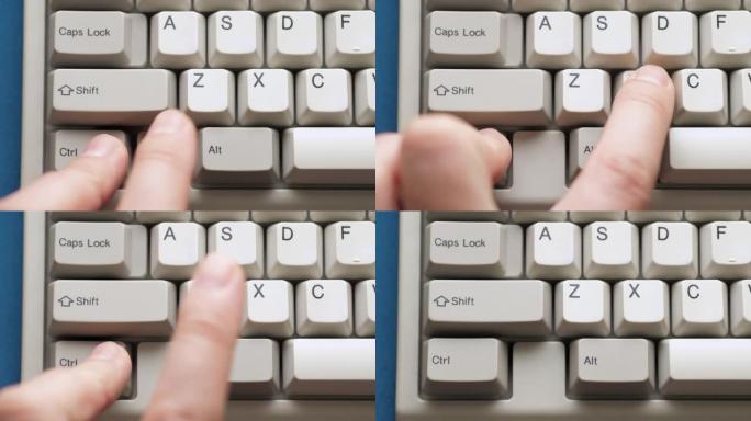 男性手指按下白色键盘上的CTRL X按钮。慢动作和宏观视图