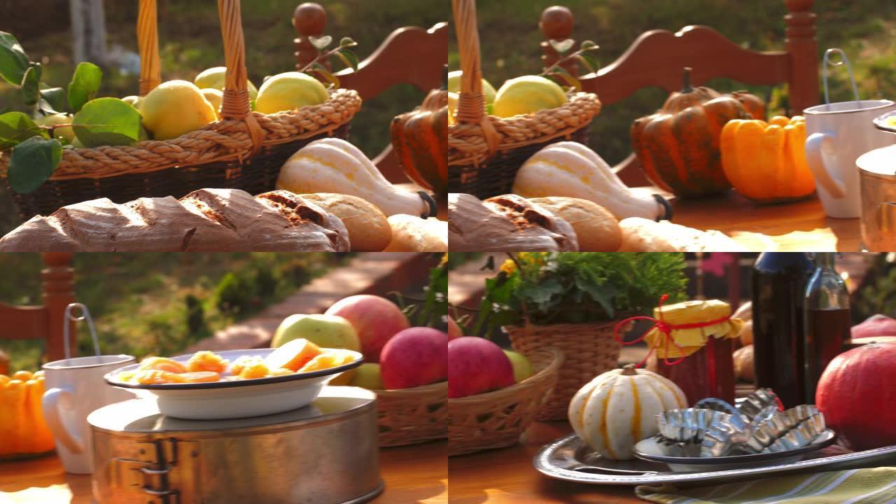 在户外桌上摆放新鲜的秋季水果和蔬菜以及自制糖果