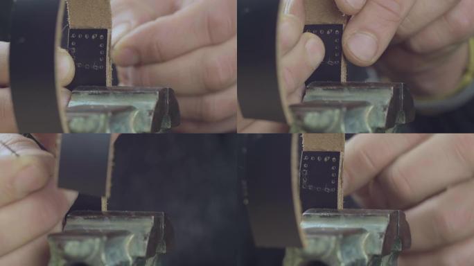 男用手缝制黑色皮革手工表带的特写针，制造过程中的优质商品。电影院4k视频。C4K