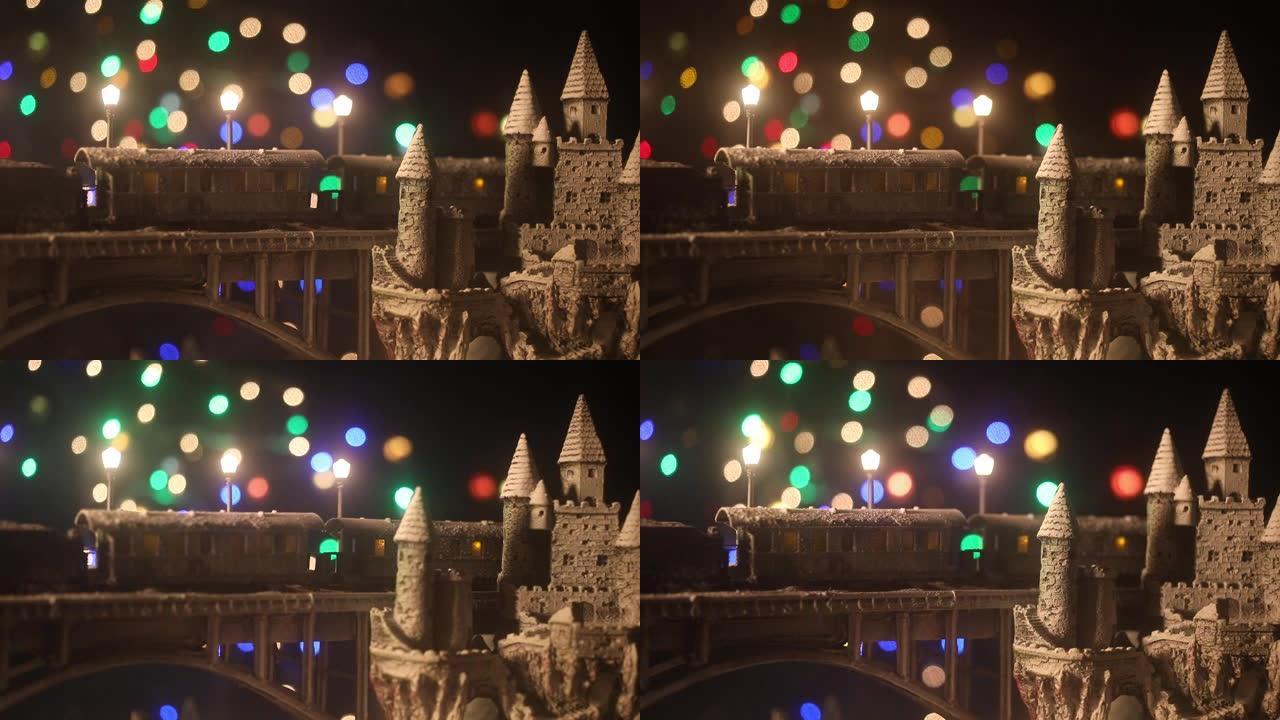 冬季雪景的缩影，火车在桥上，中世纪城堡和小城市。假日属性。夜景。新年和圣诞节的概念。创意艺术品迷你桌