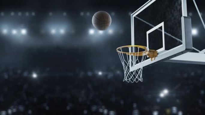 篮球在相机闪光灯的背景下以慢动作击中篮筐