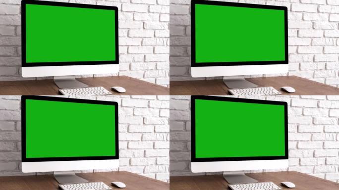木桌上的键盘和鼠标模拟绿屏电脑桌面。带色度键的工作场所概念。