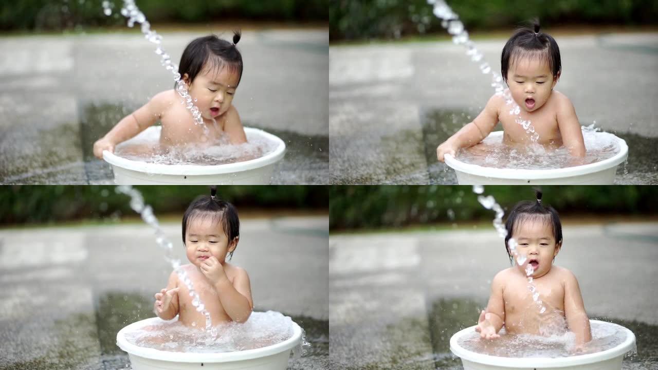 白色浴缸里的亚洲婴儿淋浴和户外在家的幸福