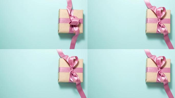 礼品概念。纸质礼物盒子，上面有粉色丝带蝴蝶结，蓝色有复印空间