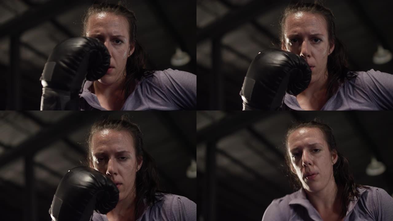 女MMA战士戴着拳击手套凝视镜头