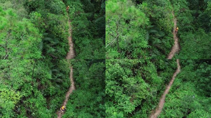 在热带森林中奔跑的女子超级马拉松运动员的鸟瞰图