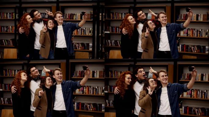 欧洲学生，四人一组在学院或大学图书馆自拍。四人一组站在书架前，开心地微笑着，打手势，表现出和平的姿态