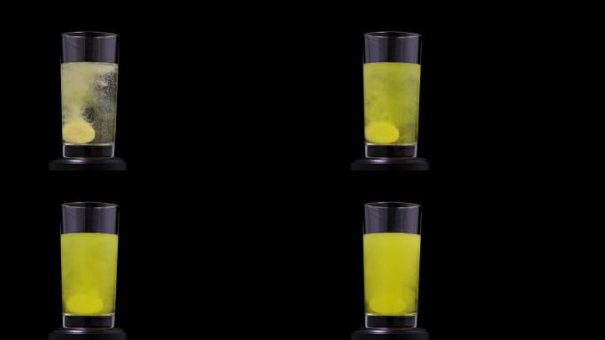泡腾黄色片剂维生素c掉落并溶解在透明玻璃中与水