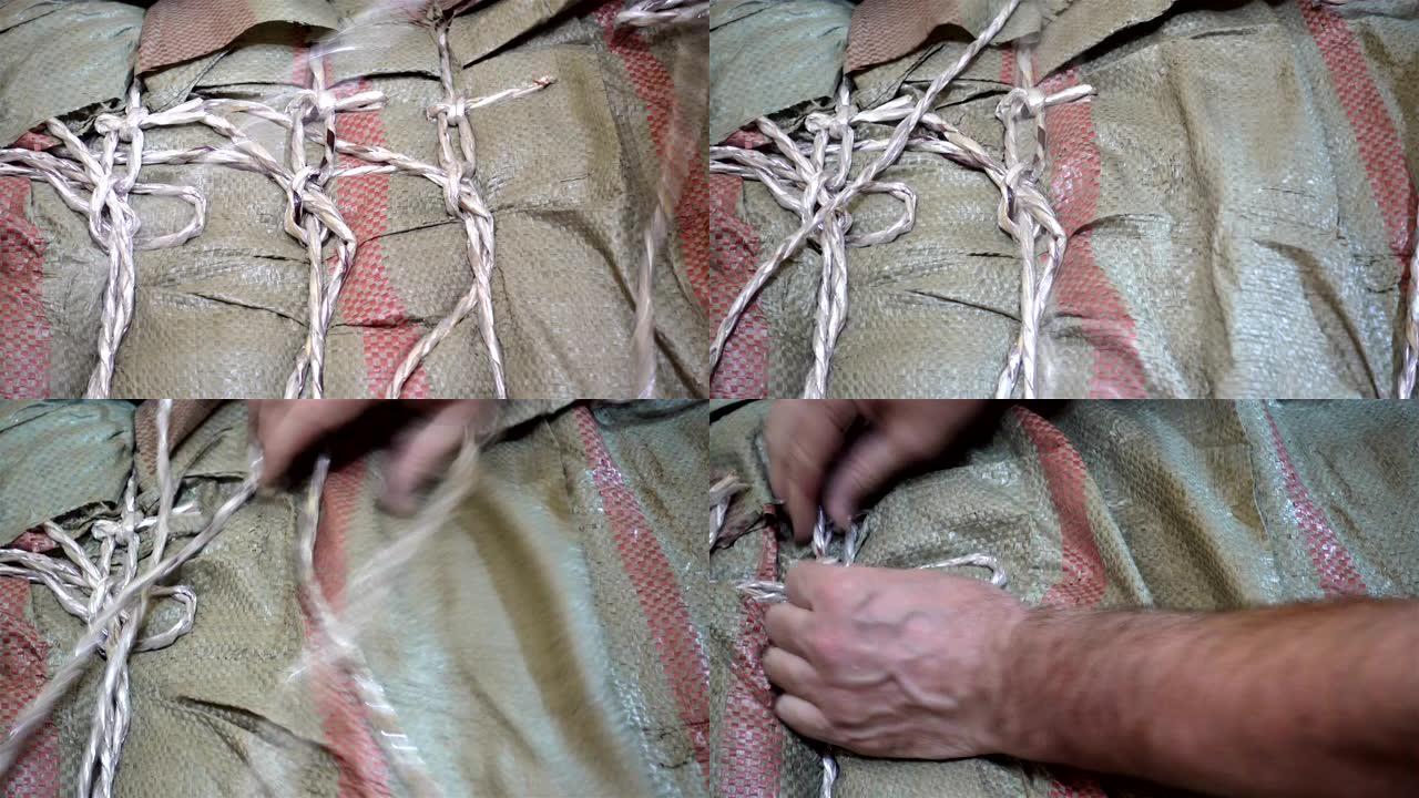 手的4k视图解开包装袋上的绳索。