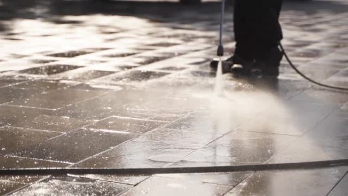 用水压清洗机清洁城市街道。看门人喷洒城市街道人行道铺路板。工人从冠状病毒消毒地板和表面。检疫抗菌卫生