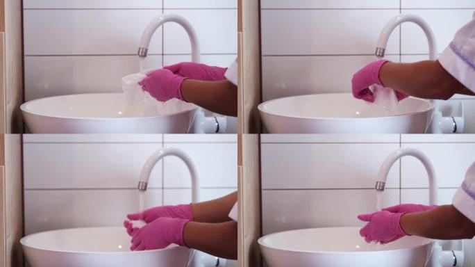 沙龙中手套洗涤工具中女性手的裁剪视图