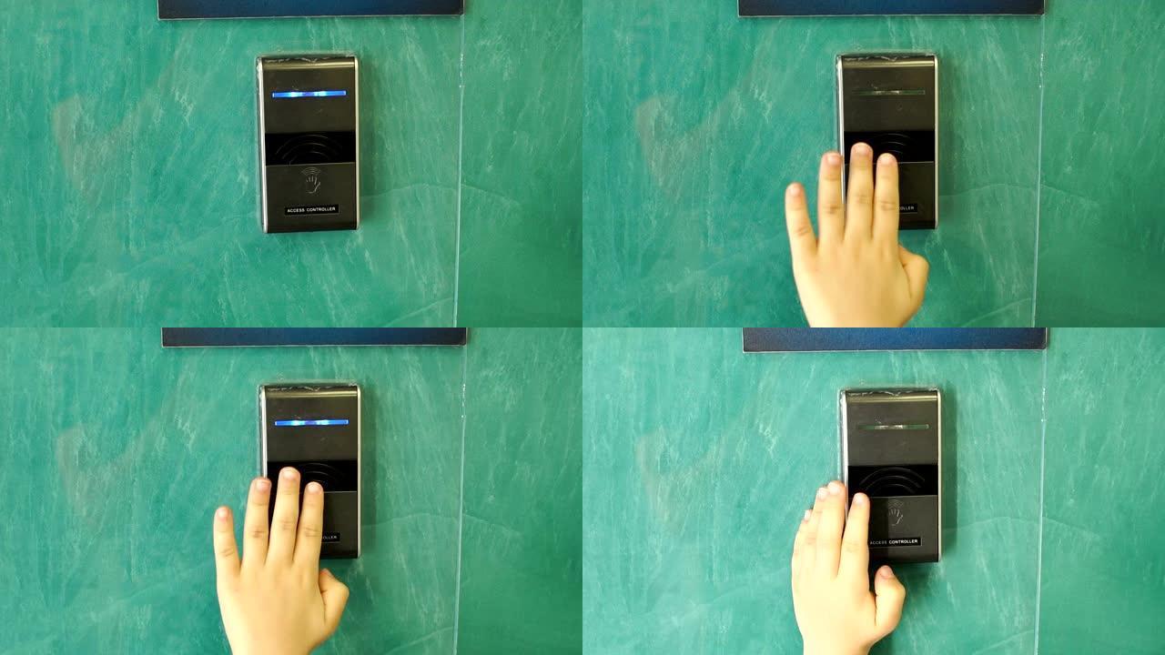 儿童用触摸键打开自动门的手的特写镜头。
