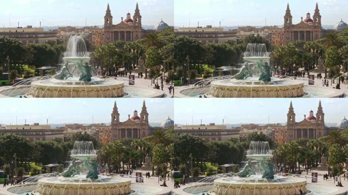 特里顿喷泉位于马耳他首都瓦莱塔市的大门前。背景教堂