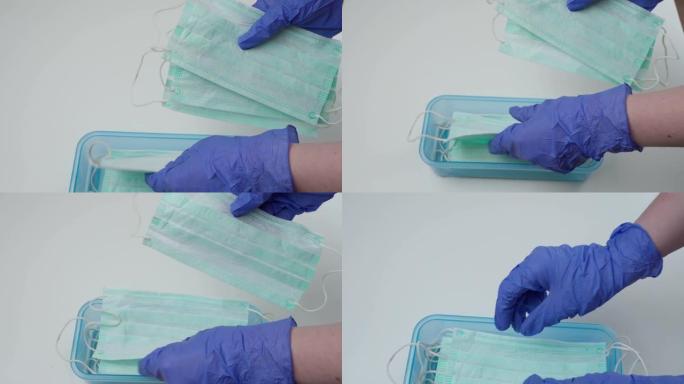 医生或护士将呼吸面罩放在塑料容器中。用医用手套保护的手。大流行保险冠状病毒，新型冠状病毒肺炎，传染性