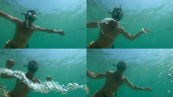 人类在水下玩耍和制造泡泡。Freediver创建了在水下移动的气泡环