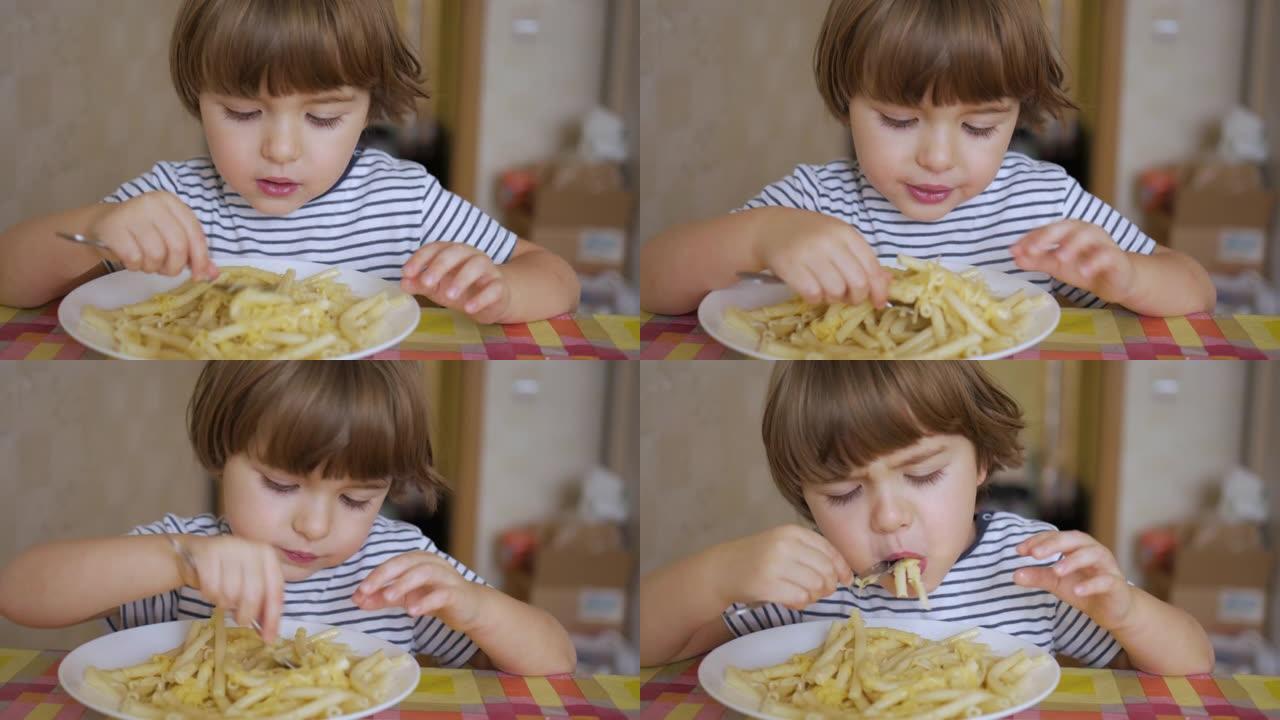 可爱的小男孩在厨房吃奶酪意大利面。肖像有趣的健康学龄前儿童男孩吃意大利面。饥饿的孩子用手吃饭，在家微