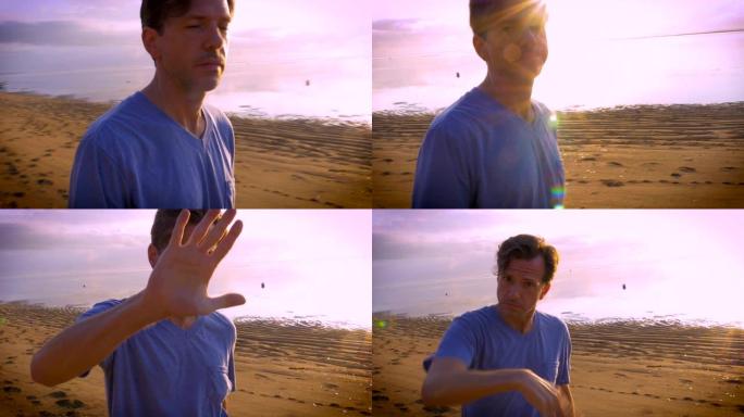 男子向摄像机示意停止在海滩上拍摄他