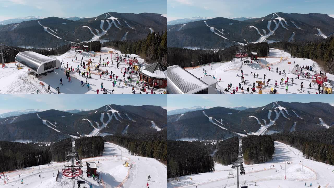 鸟瞰图滑雪者在滑雪缆车附近的山顶滑雪场上滑雪。滑雪胜地