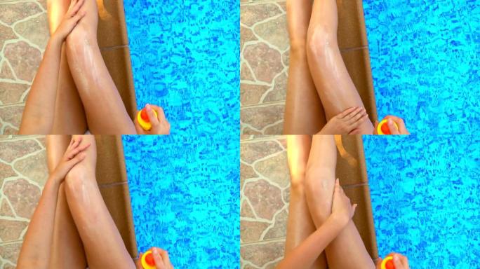 女人在腿上涂抹防晒霜。