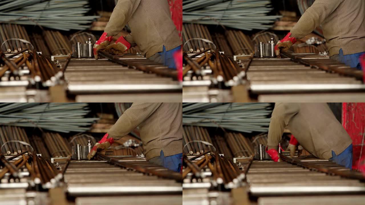 使用滚筒机机床的手套工人专家。用于金属钢筋弯曲的工业弯管机。选择性聚焦。