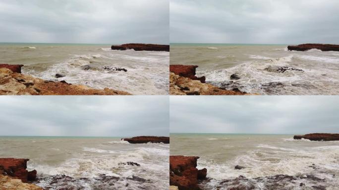 暴风雨来临前，海浪正冲入一个岛屿的岩石悬崖。4k