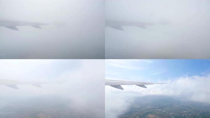 飞机的机翼在后退的土地上飞过云层