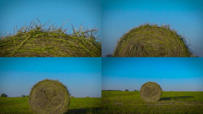 田野里的一堆干草和一台拖拉机
