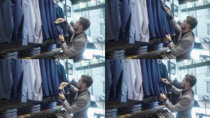 男装商店老板用羊毛刷刷和清洁套装