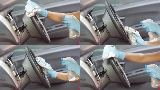 清洁汽车内部和喷洒消毒液体。双手戴着橡胶防护手套消毒体内毒物，防止病毒电晕病