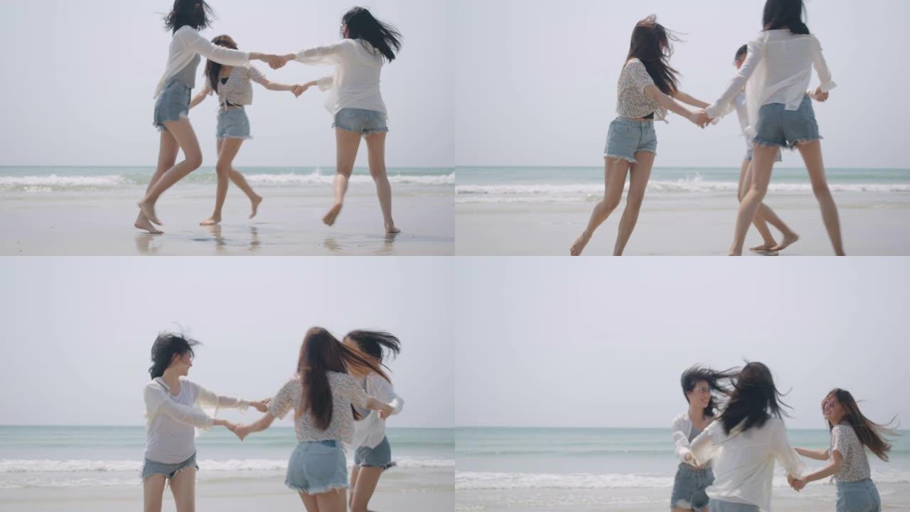 微笑快乐的亚洲朋友一群女人在海滩上手牵着手海边暑假假期旅游享受生活周末活动人们的生活方式，慢动作4k