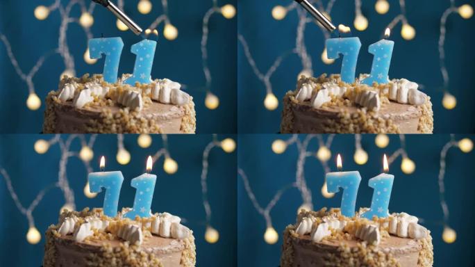 蓝色背景上有71号蜡烛的生日蛋糕。蜡烛着火了。慢动作和特写视图