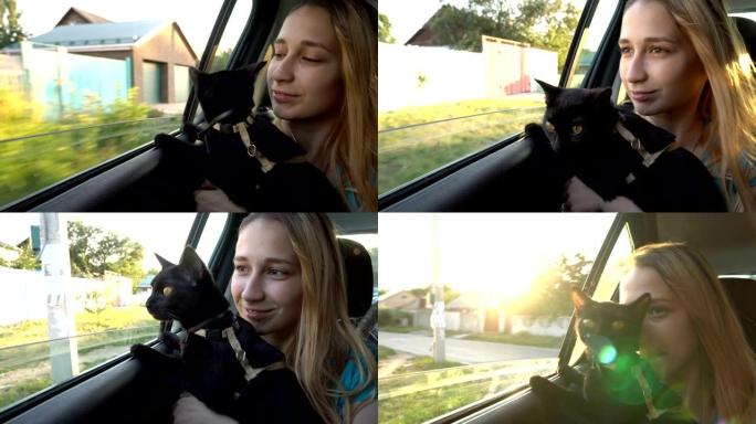 一个年轻女孩在驾驶汽车的后座上抱着一只黑猫，他们一起看着窗外。特写。从车内看。4K