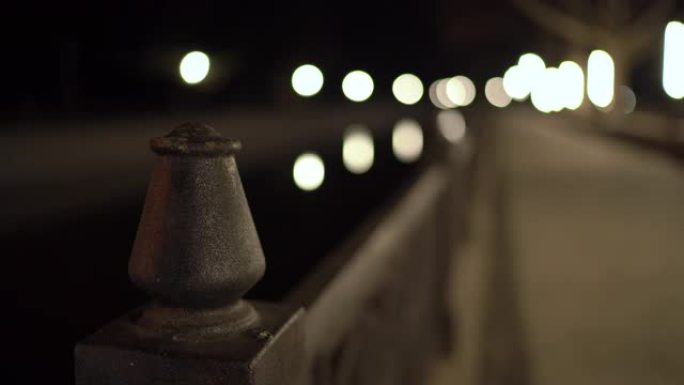 夜间灯笼点亮的河堤铸铁围栏