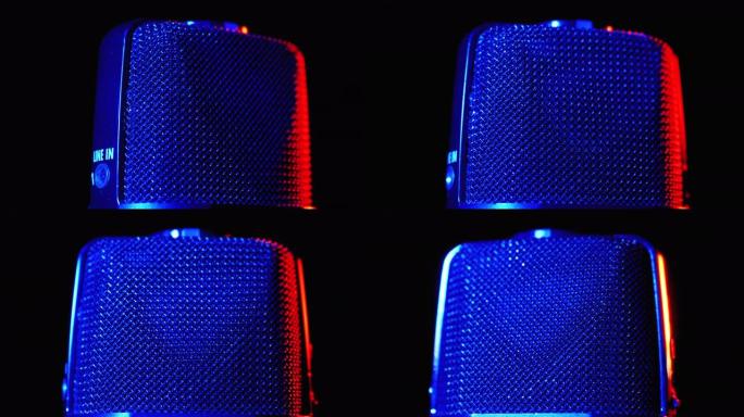 电容式麦克风在蓝色和红色背光的情况下旋转。专业录音机特写