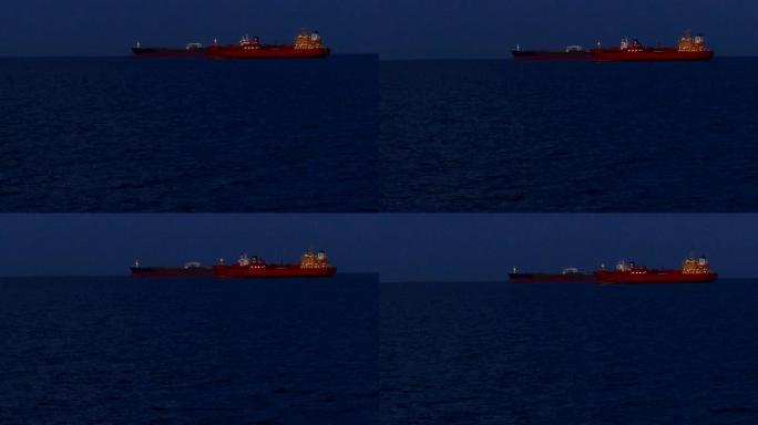公海有夜灯的油轮和货船