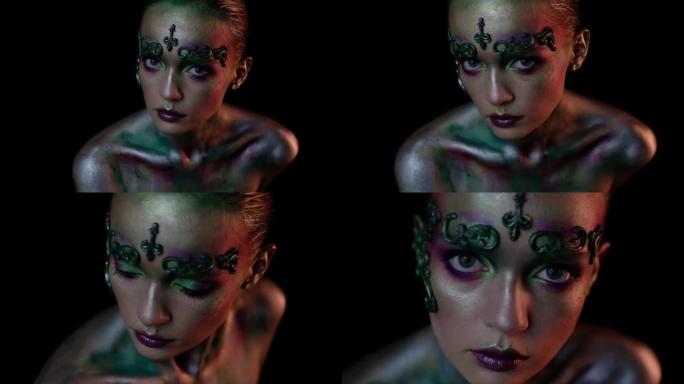 黑色背景上的创意妆容女孩看着镜头并移动