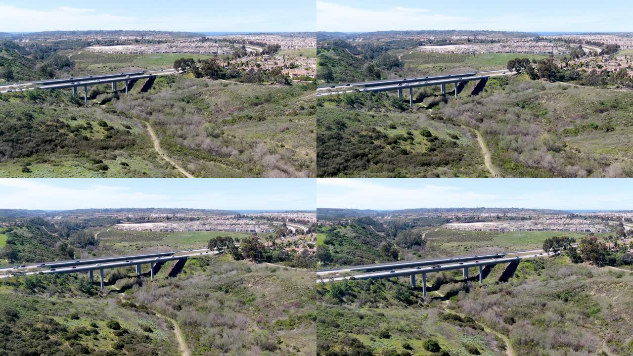 公路大桥鸟瞰图，高架桥支撑在青山之间的山谷中