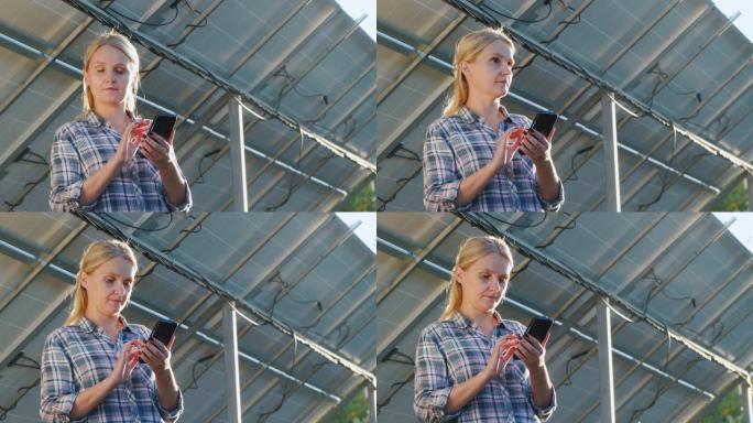一名妇女使用应用程序来说明太阳能电池板的产生。它位于家用太阳能发电厂